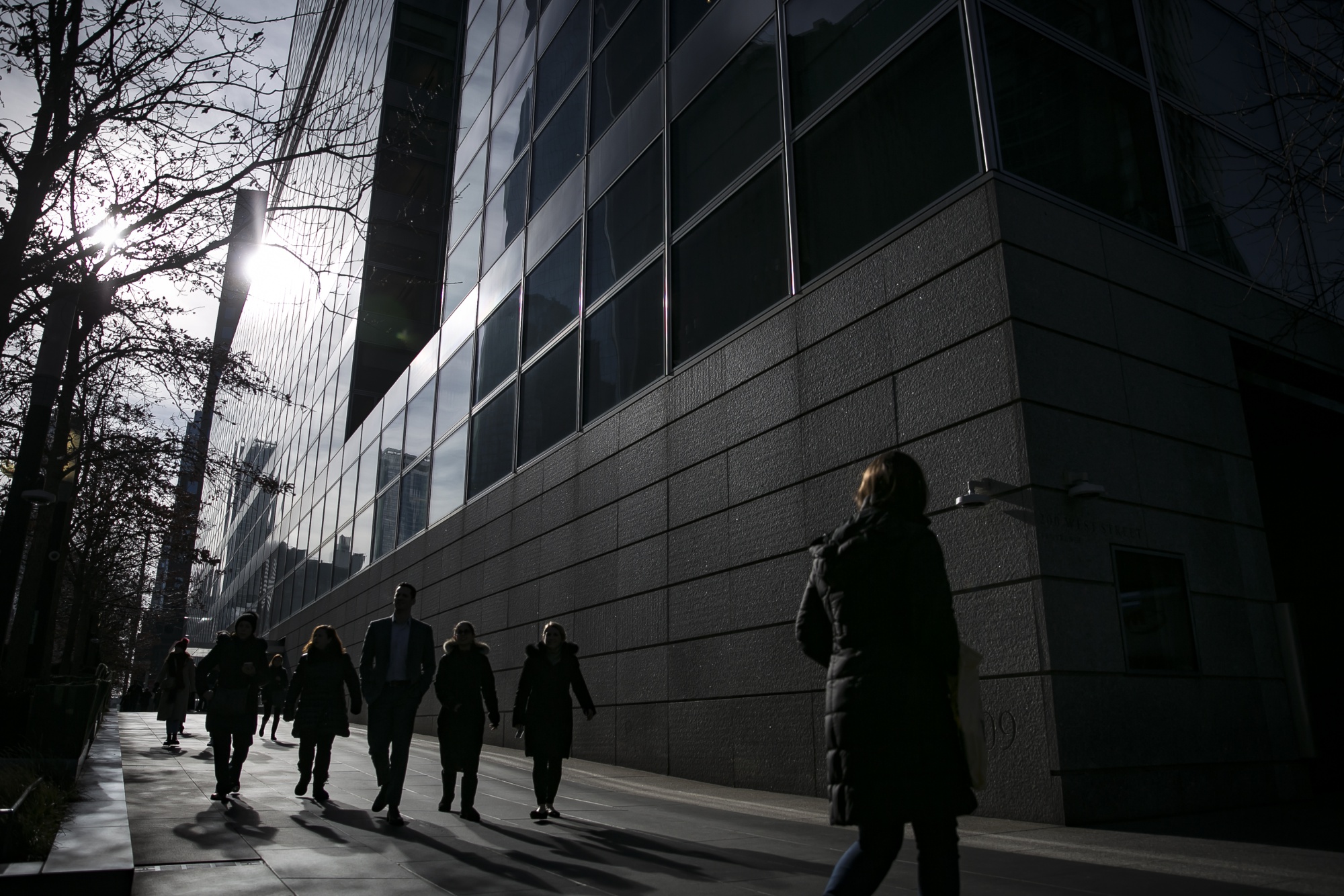 Pedestrians pass in front of Goldman Sachs Group Inc. headquarters in New York.