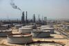 Crude oil storage tanks stand at the oil refinery operated by Saudi Aramco in Ras Tanura, Saudi Arabia.