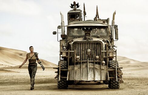 As one-armed Furiosa, Theron assuredly drives her own War Rig.