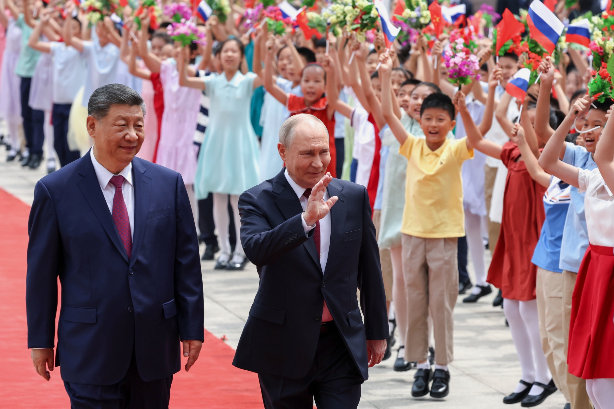 Xi Jinping and Vladimir Putin attend a welcome ceremony at the Great Hall of the People in Beijing on May 20. Photographer: Alexander Kazakov/AP Photo