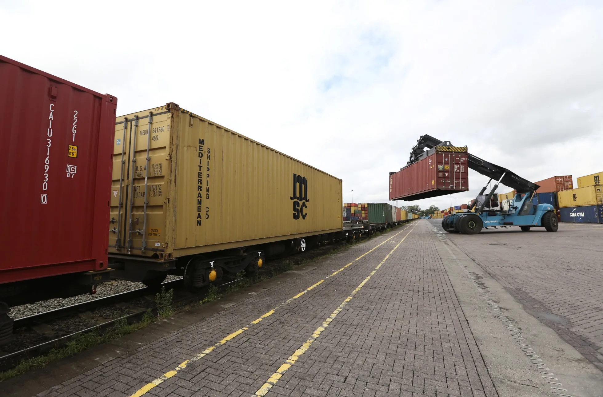 A crane loads a shipping container on to a freight wagon at an Associated British Ports terminal&nbsp;in Birmingham, UK.