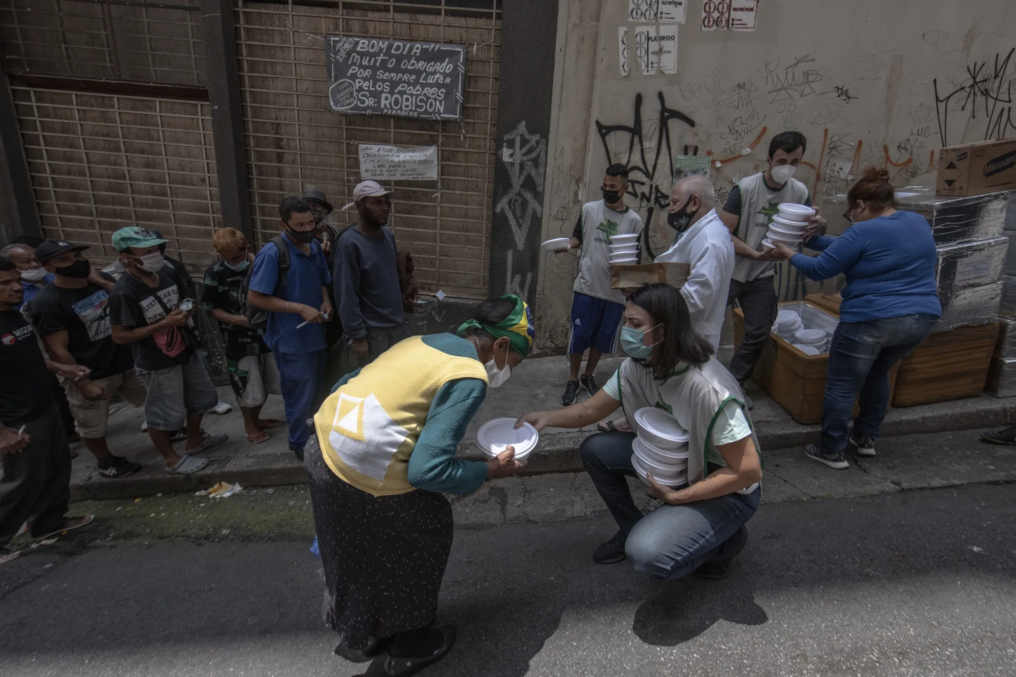 Members of the State Movement for the Homeless Population (MEPSR) hand out food donations in Sao Paulo on Oct. 26. MEPSR estimates that the number of people who can’t afford housing has tripled since 2019.