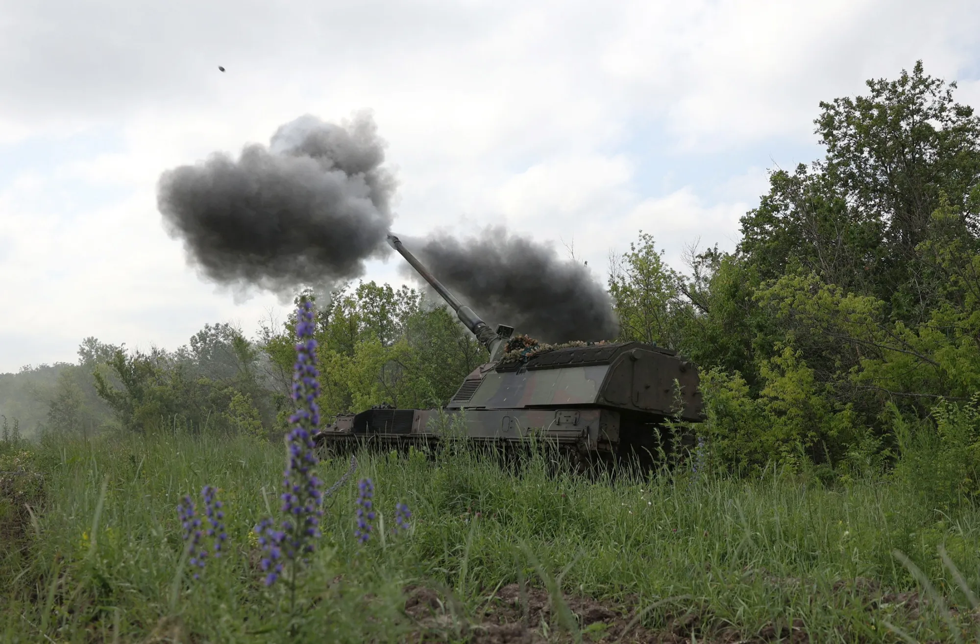 A Ukrainian artillery unit fires a PzH 2000 howitzer towards Russian positions.