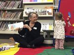 Children's librarian Chere Brown reads to toddlers at the Josephine County library in Grants Pass, Oregon, whose public funding was restored by voters in 2017. 