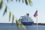 The U.S. national flag flies as the liquefied natural gas (LNG) tanker Oak Spirit, operated by Teekay Corp., sits docked with Poland's first import of U.S. LNG at the Gazoport terminal, operated by Polskie LNG SA, in Swinoujscie, Poland, on Friday, July 26, 2019. 