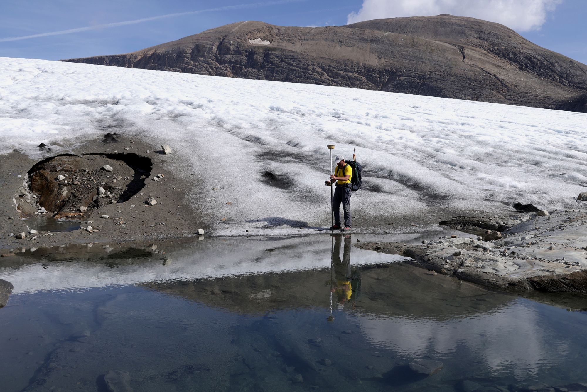 A geographer records a GPS reading at the terminus of the Wasserfallwinkel Kees glacier. Photographer: Sean Gallup/Getty Images