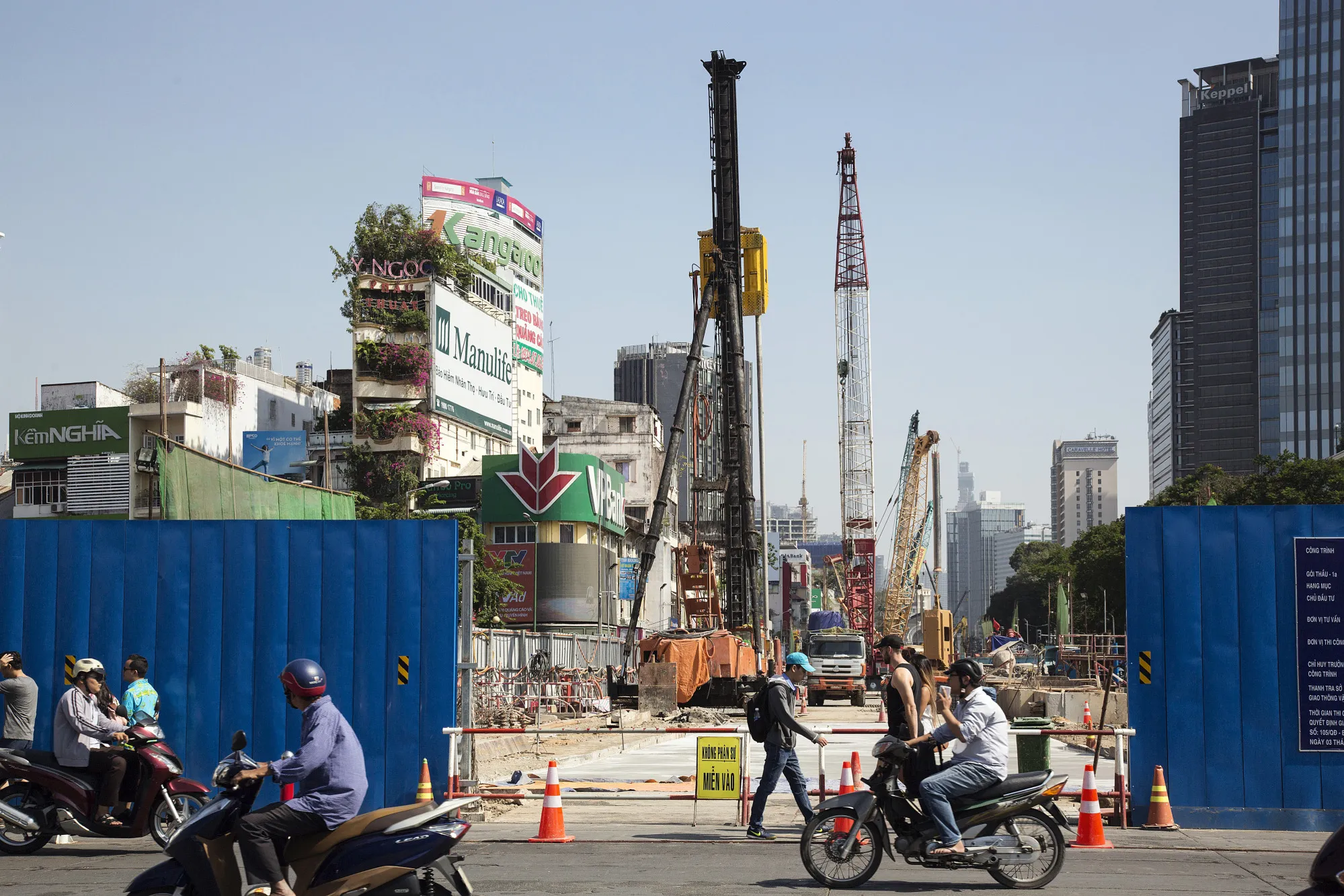 Motorists and pedestrians pass a construction site of a metro line in Ho Chi Minh City, Vietnam, on&nbsp;Jan. 11, 2018.