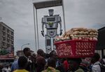 People gather on March 3, 2015, at the official presentation ceremony of three new robots recently installed in Kinshasa to help tackle the hectic traffic of the capital.