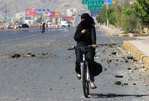 A Woman Rides A Bicycle In Sana'a As Yemen Faces Fuel Shortage