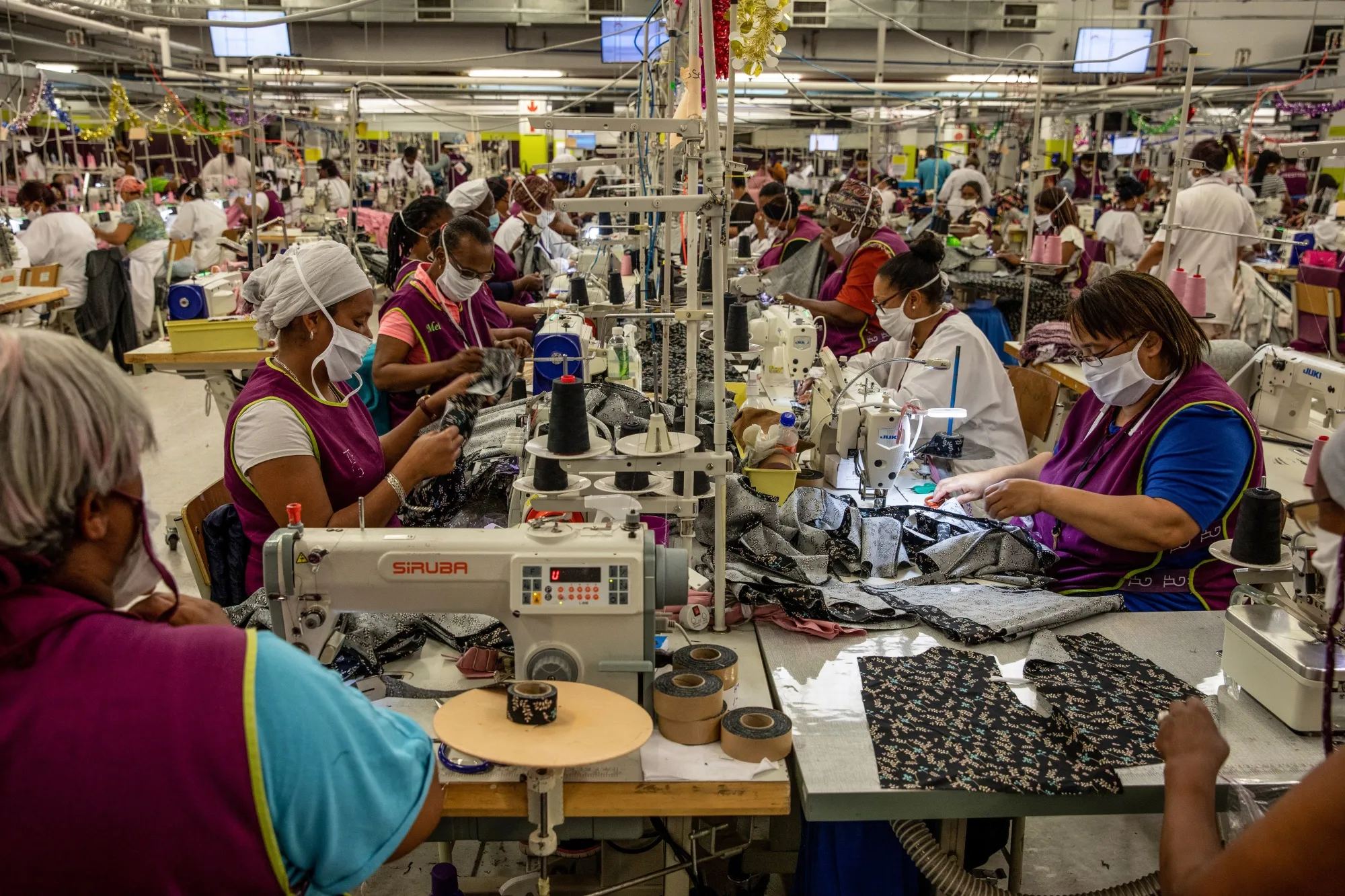 Workers sew garments at a factory in Cape Town, South Africa.