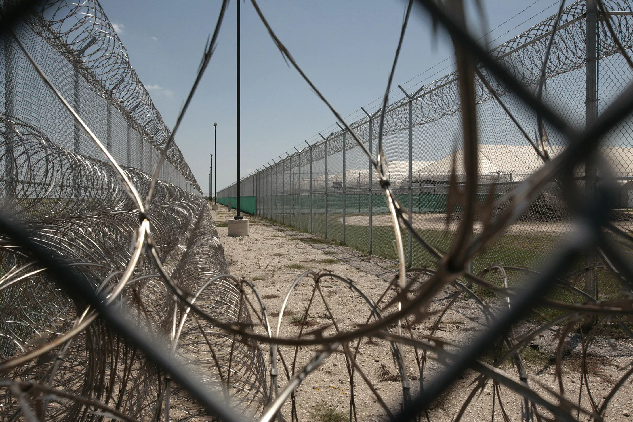 Barbed wire and security cameras surroun