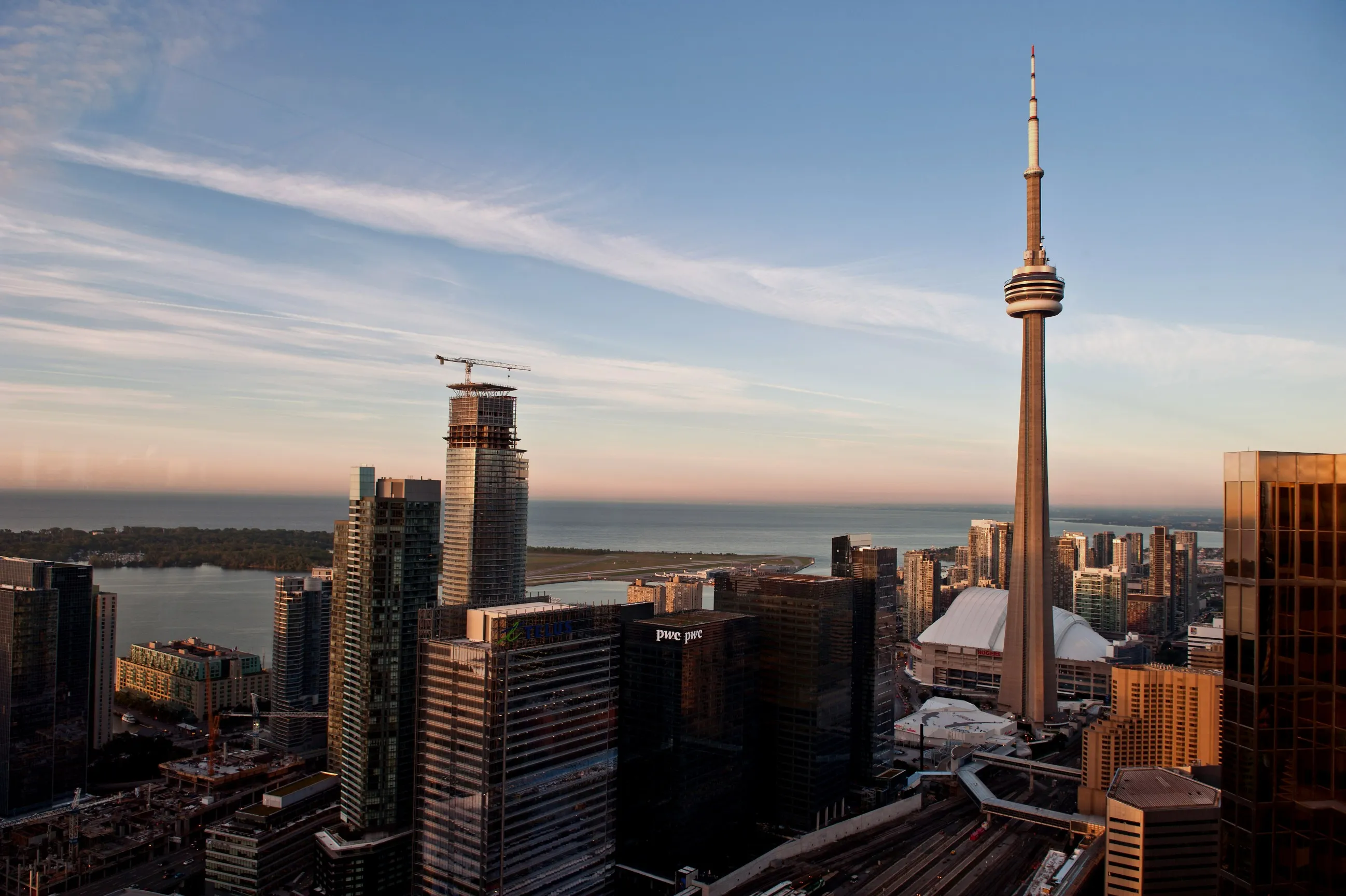 The CN Tower, right, stands next to buildings under construction in the skyline of Toronto.
