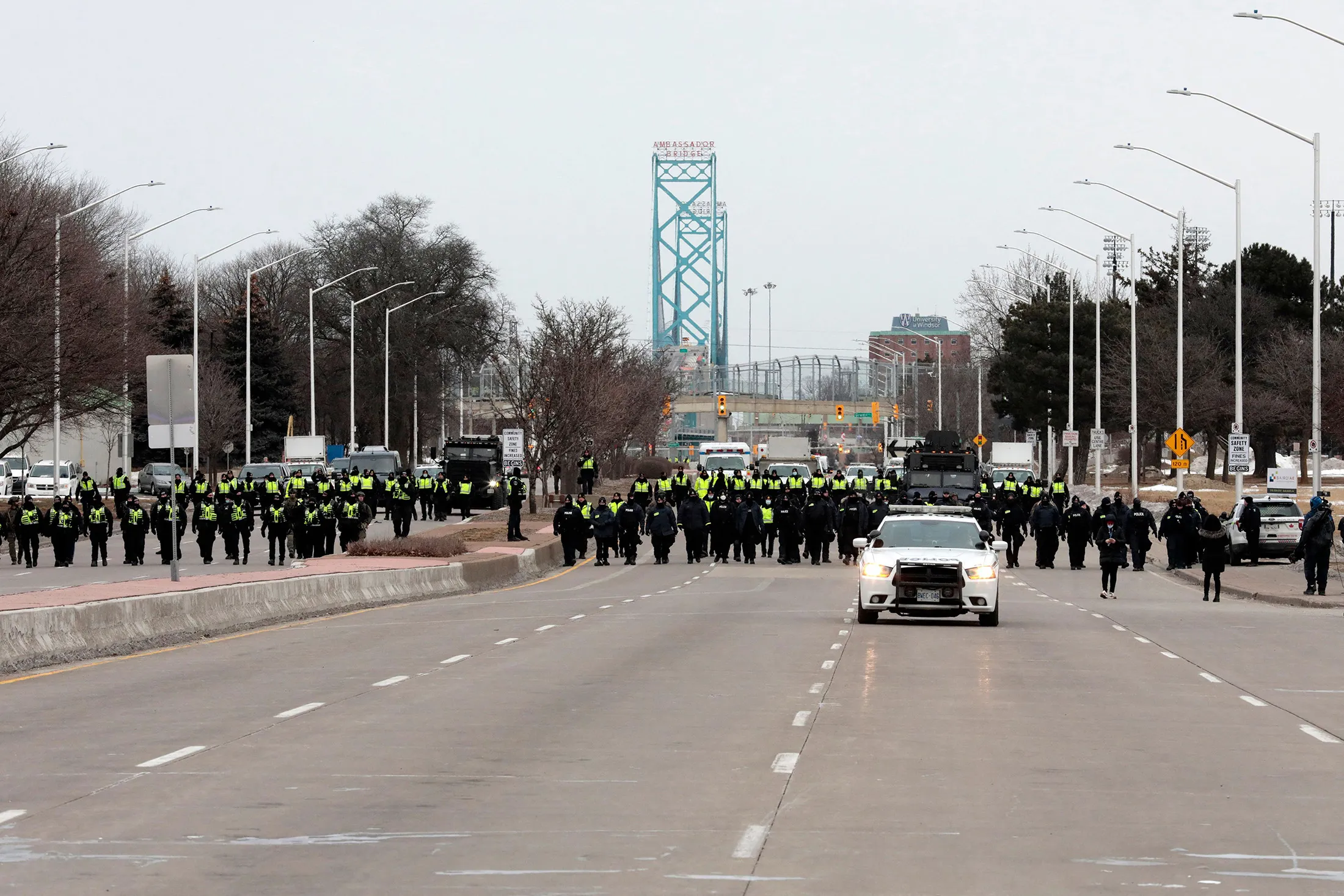 Police gather to clear protesters blocking the entrance to the Ambassador Bridge in Windsor, Ontario, Canada, on Feb. 13.