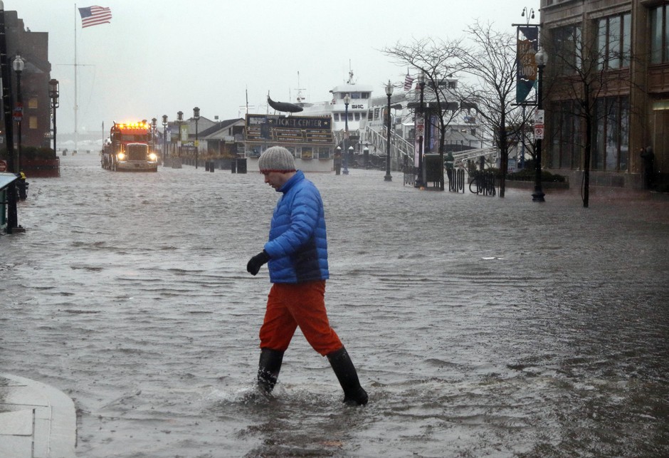 A man wades across State Street in Boston, flooded by water from Boston Harbor at high tide during the March 2 nor'easter.