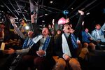 Customers raise their hands during a countdown at the launch of the Sony Computer Entertainment Inc. PlayStation 4 (PS4) video game console at the Sony showroom in Tokyo. Photographer: Tomohiro Ohsumi/Bloomberg