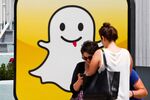 People take pictures in front of of the headquarters of the photo sharing app SnapChat on the strand at Venice Beach in Los Angeles, California, U.S., on Wednesday, August 14, 2013.
