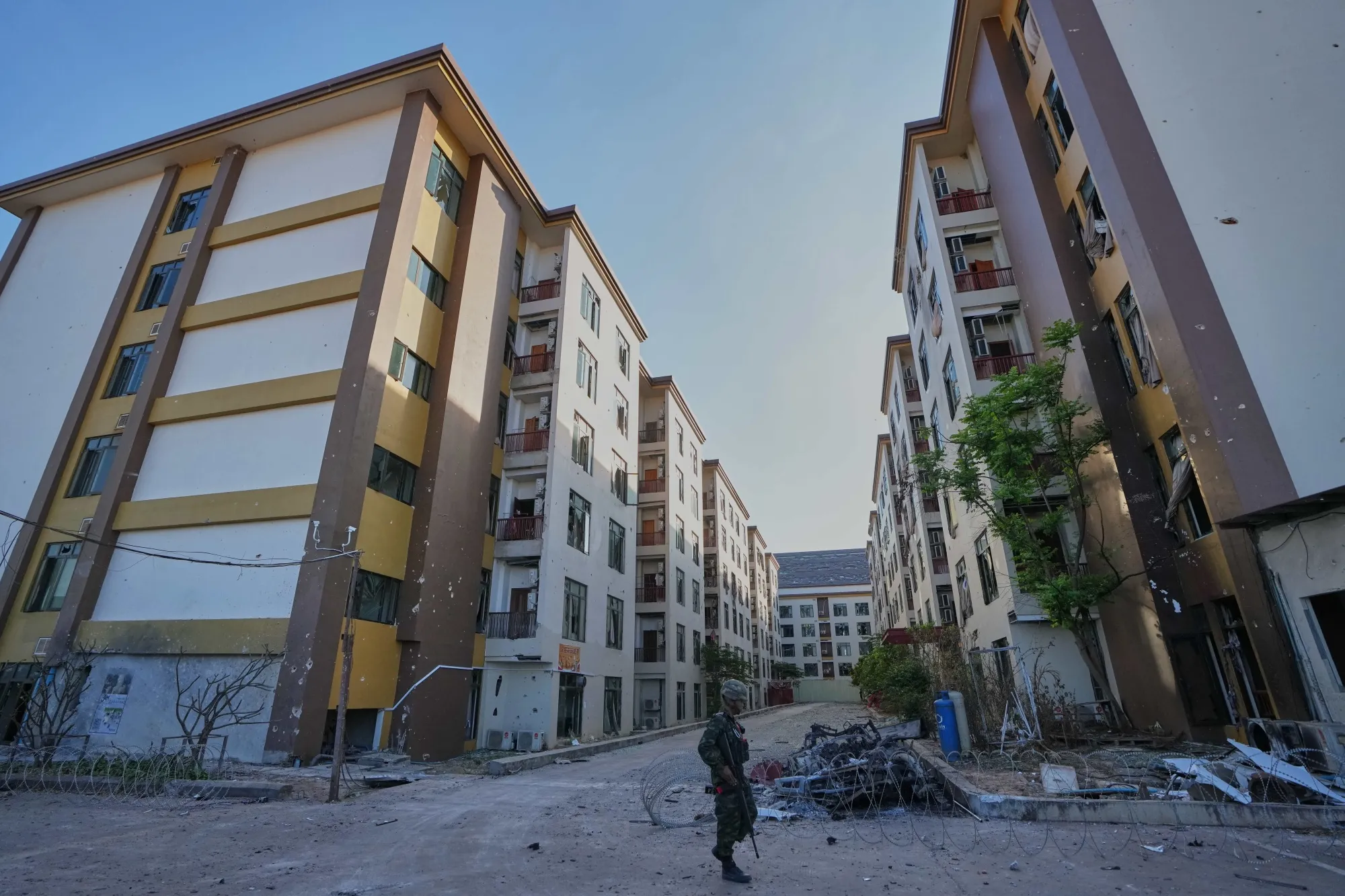 A soldier keeps guard outside a scam center in O'Smach, Cambodia on Feb. 2.
