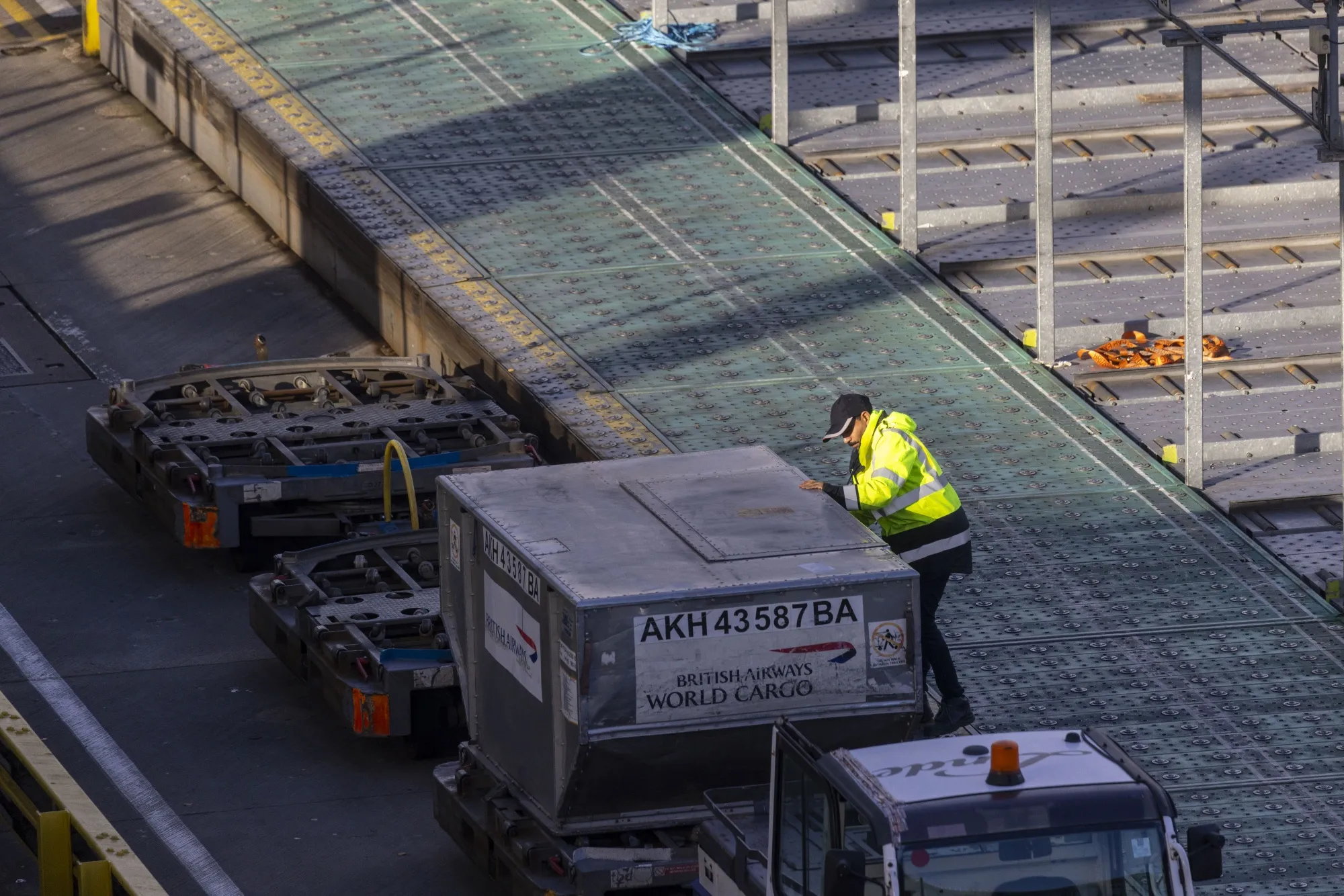 A cargo handler prepares air freight containers