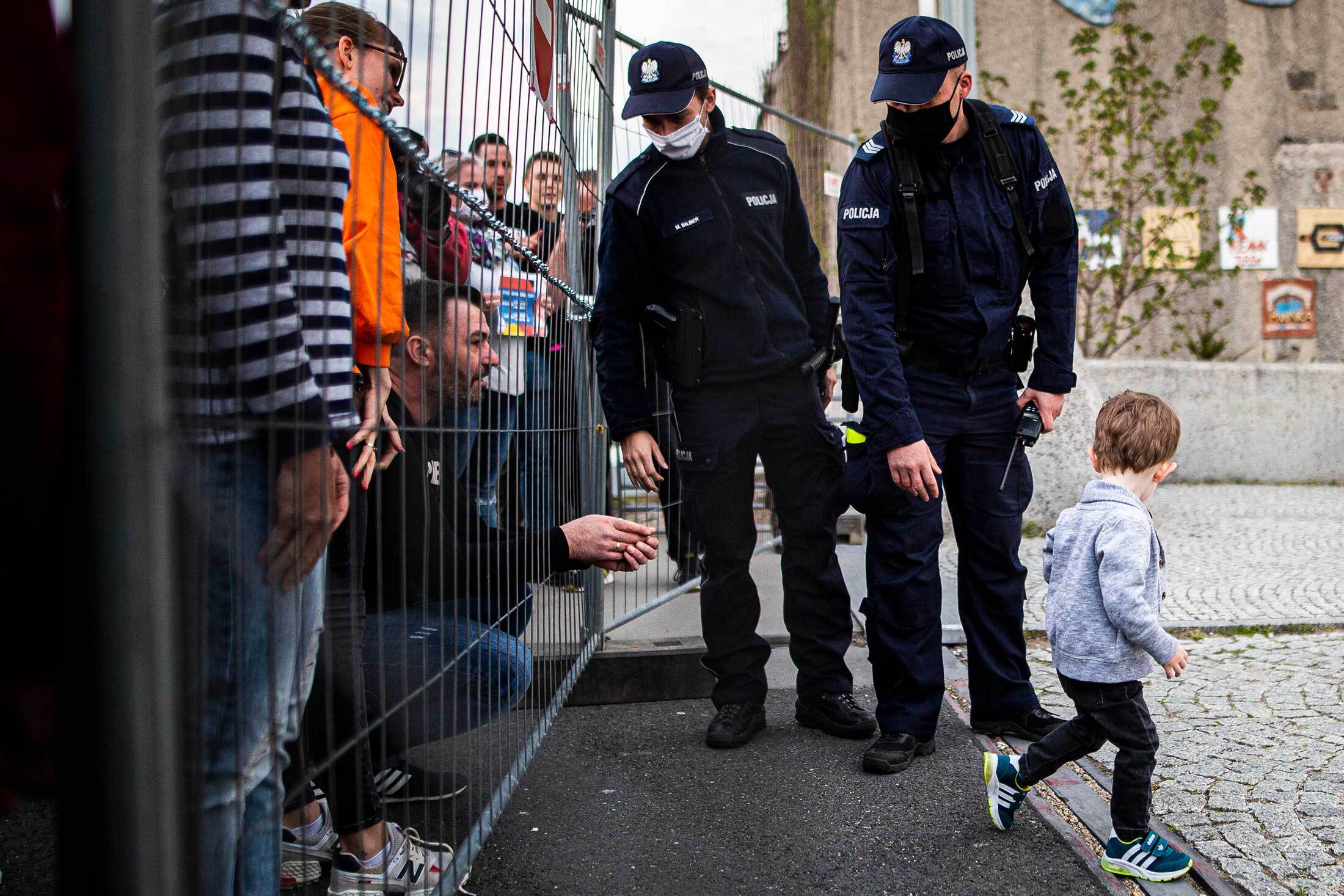 A child trying to walk to his father is stopped by police officers during a demonstration against the closed German-Polish border in

Görlitz, Germany.