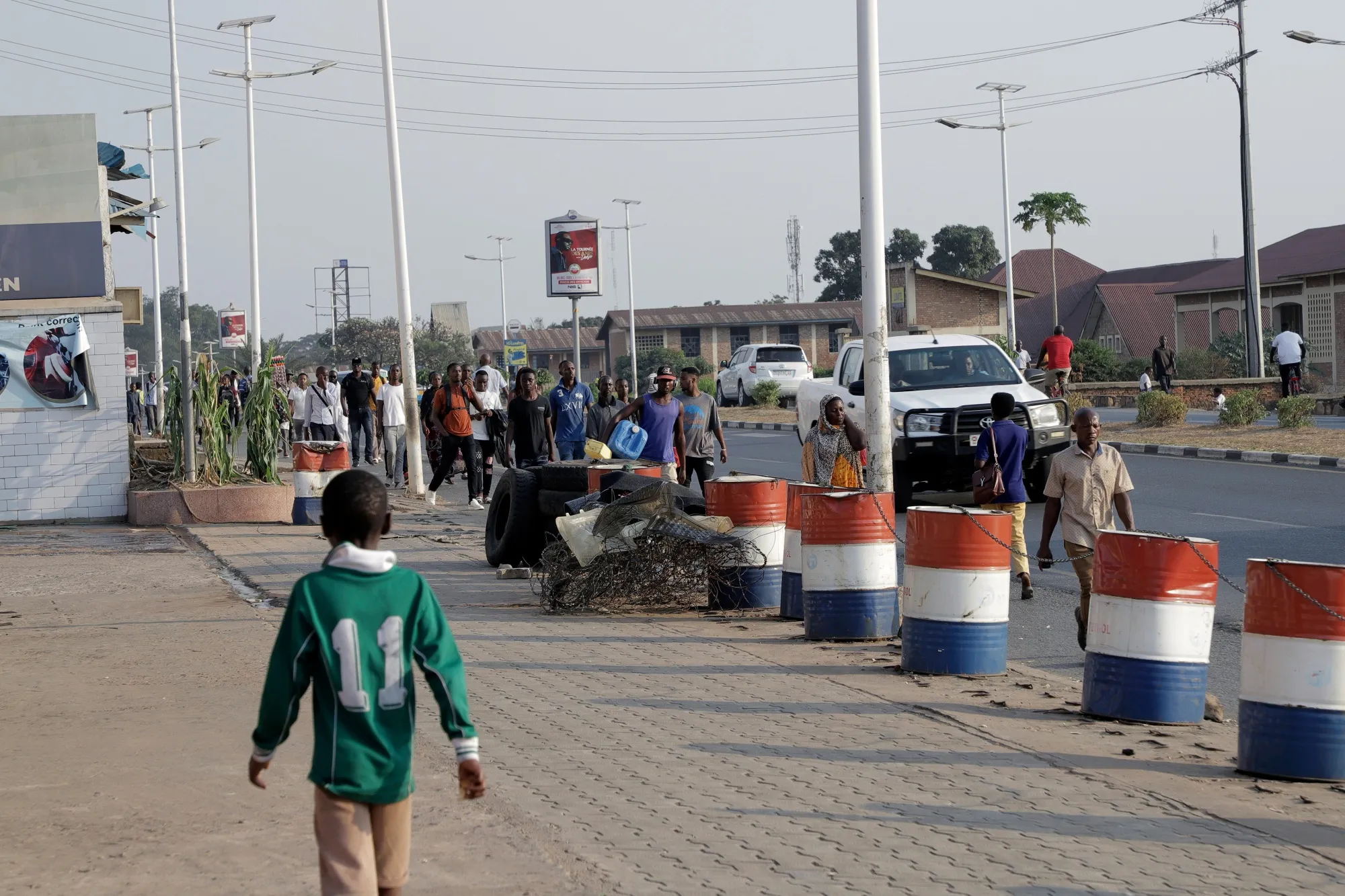 People walk past a gas station which ran out of fuel in Bujumbura, Burundi.