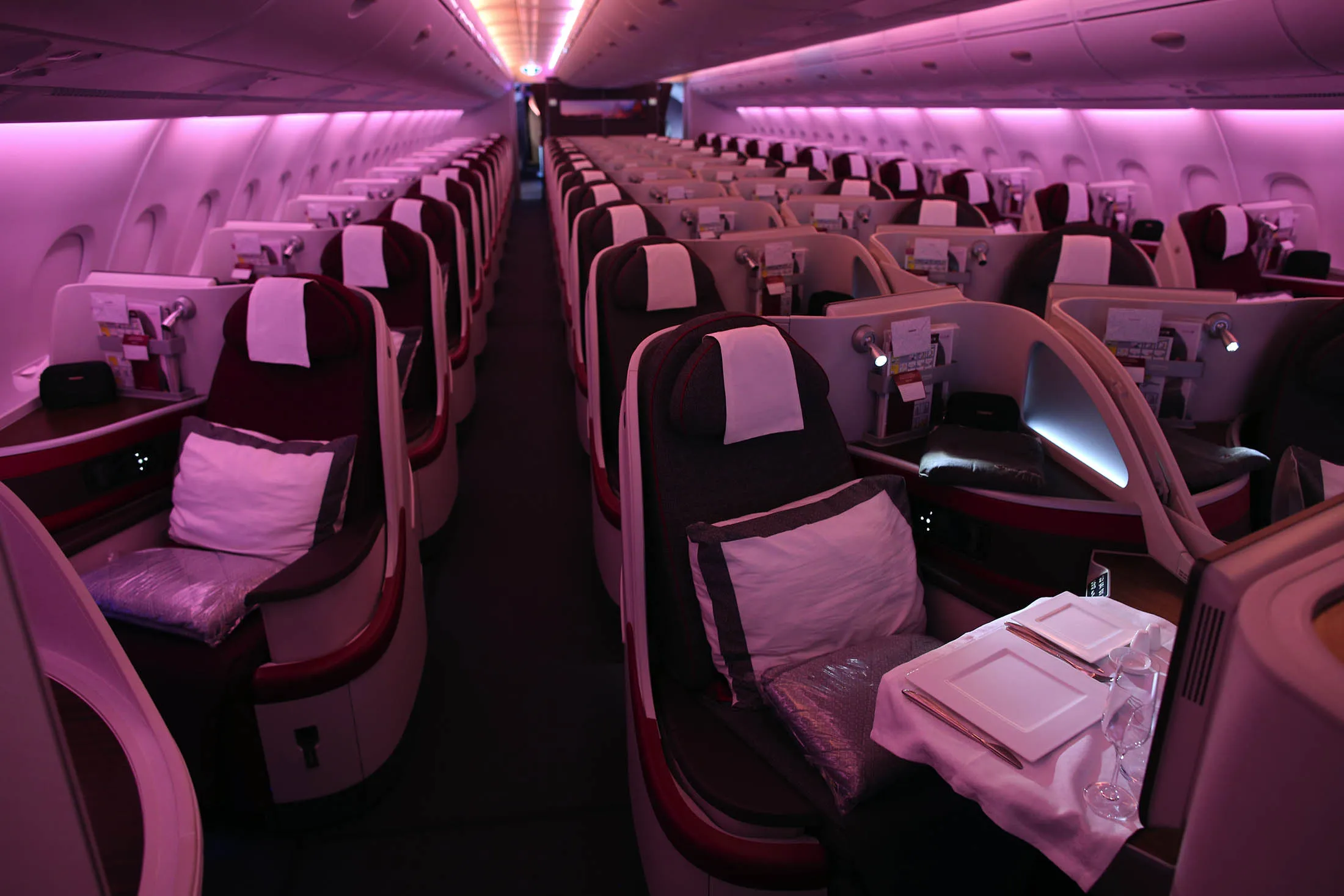 Passenger seating sits in the business class cabin of an Airbus A380-800 aircraft, operated by Qatar Airways.
