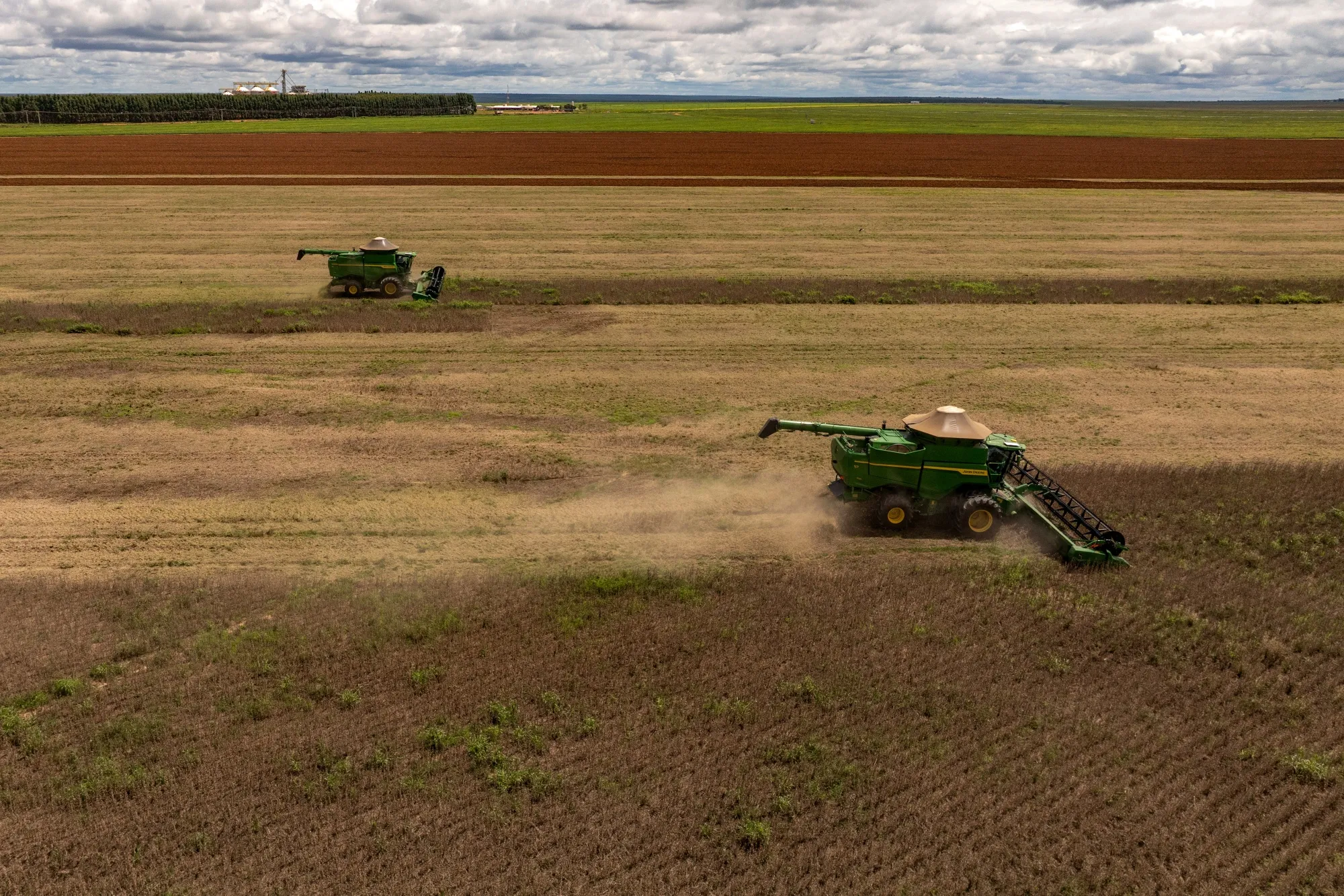Combine harvesters in a soybean field during a harvest near Mambai, Goias state, Brazil.