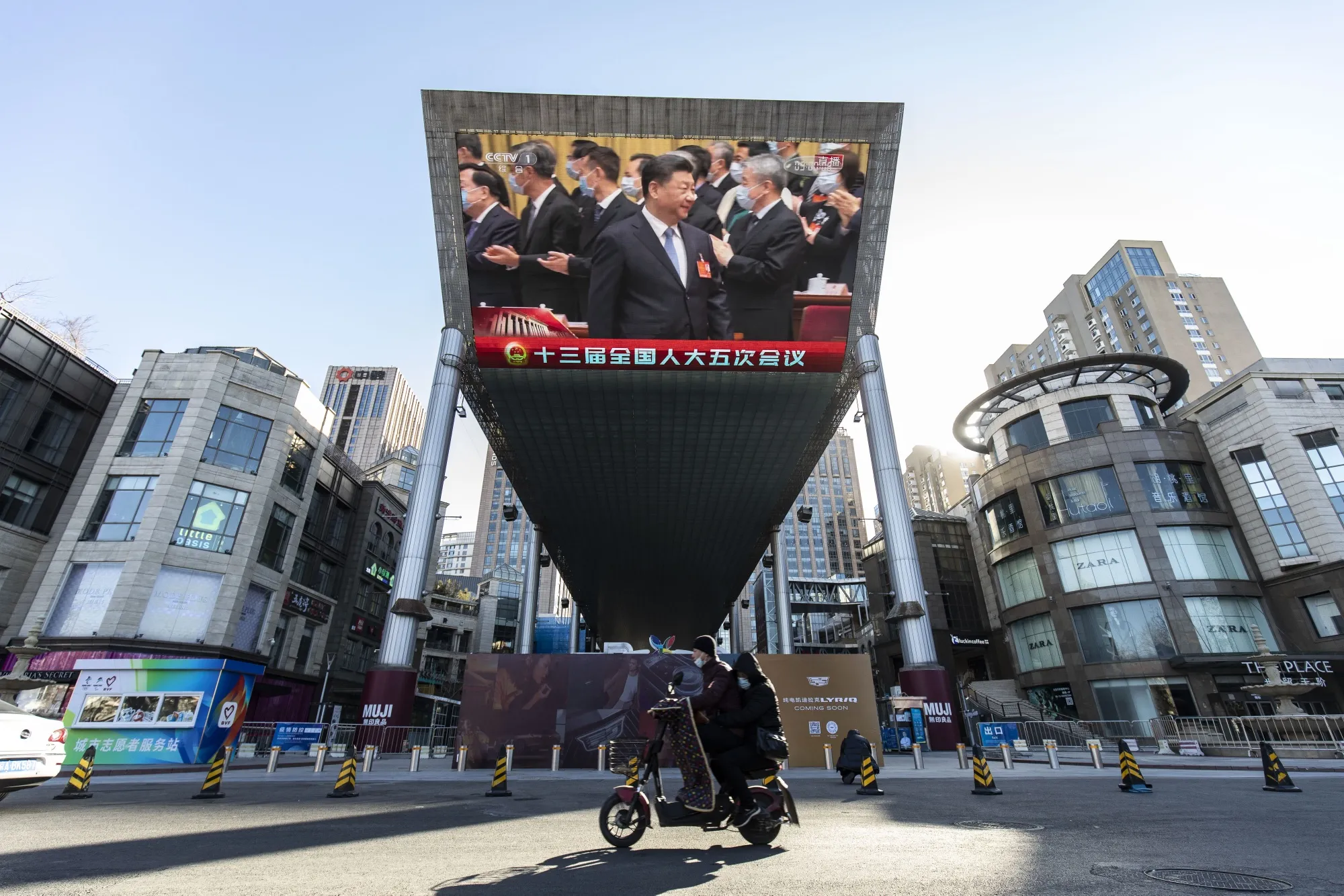 A screen displays a live news broadcast of Xi Jinping at the National People's Congress in Beijing, China, on March 5.