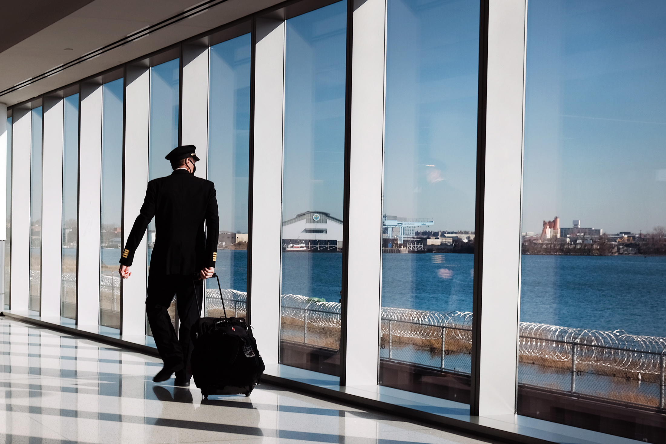 Travelers Move Through LaGuardia Airport As Pandemic Continues