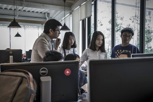 A team huddles for a group meeting in Shanghai.