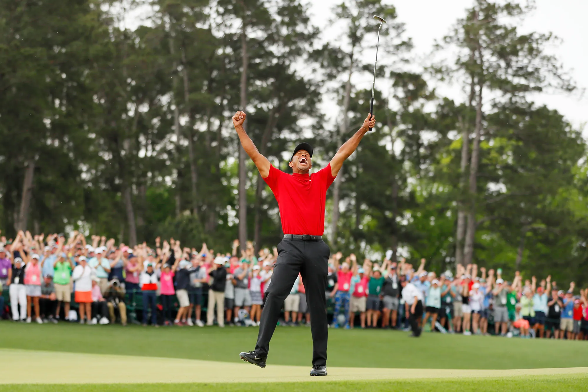 Tiger Woods of the United States celebrates after making his putt on the 18th green to win the Masters at Augusta National Golf Club on April 14, 2019 in Augusta, Georgia.