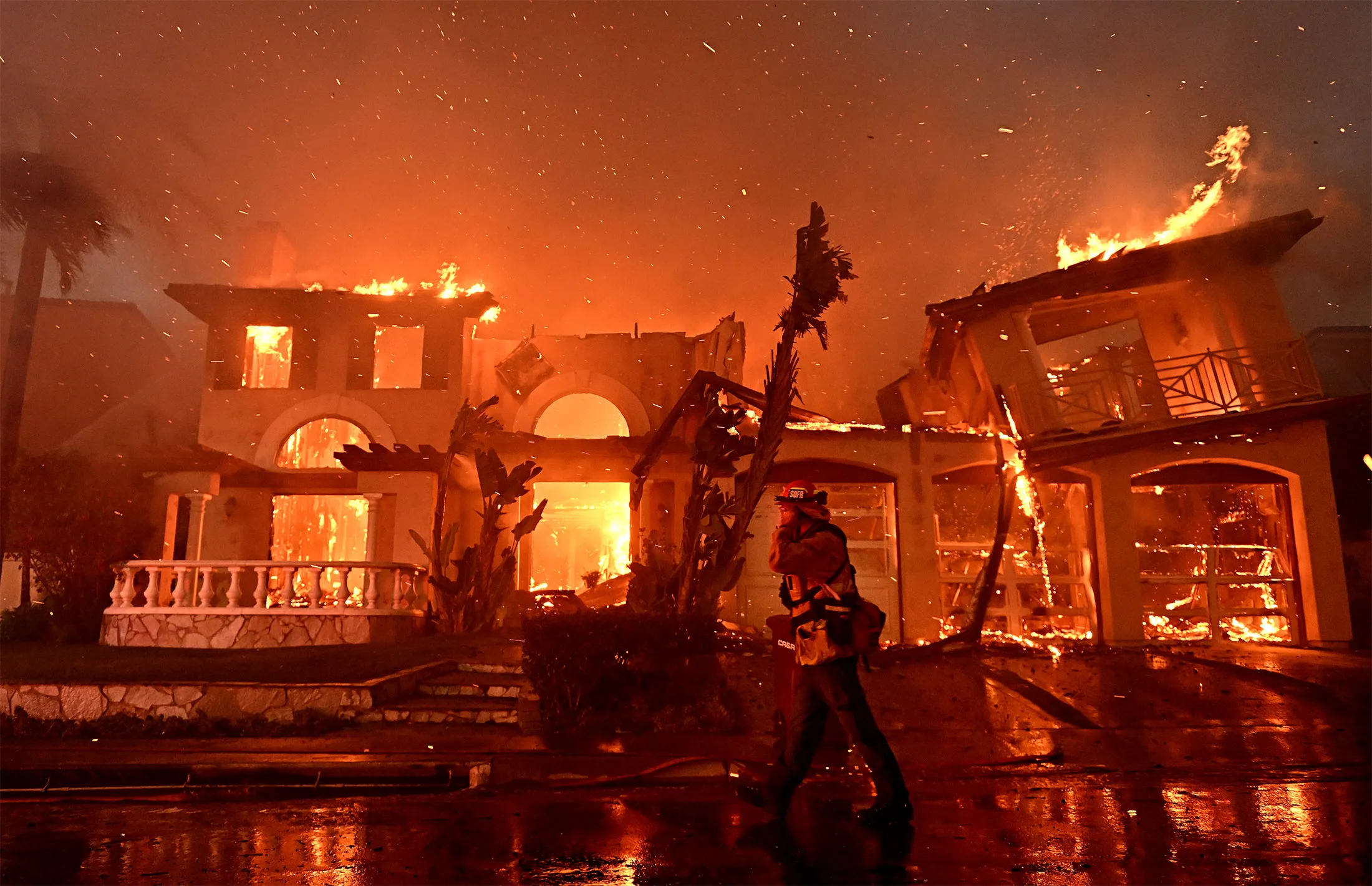 A home burns on&nbsp;Coronado Pointe during the Coastal Fire in Laguna Niguel, California, on May 11.