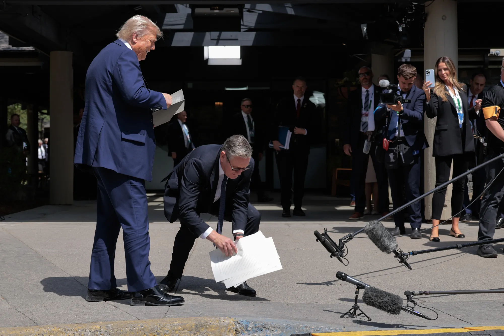 Keir Starmer pick ups the signed trade agreement Donald Trump dropped during the G7 Leaders’ Summit in Kananaskis, Alberta, on June 16.
