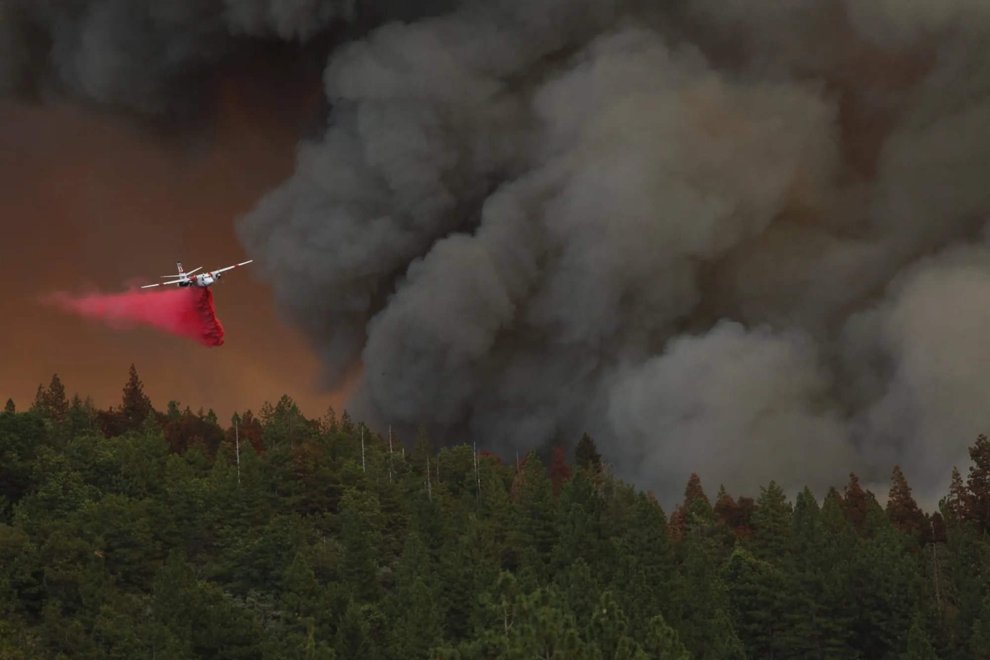 A plane drops fire retardant during the Mosquito Fire near Michigan Bluff, Calif., on&nbsp;Sept. 7.