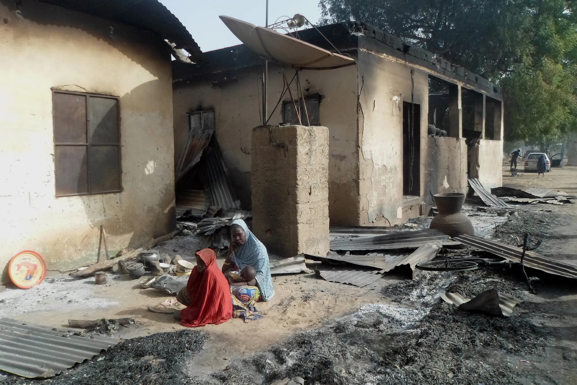 A mother sits mourning the death of her husband after Boko Haram attacks at Dalori village on the outskirts of Maiduguri in northeastern Nigeria on January 31, 2016.
