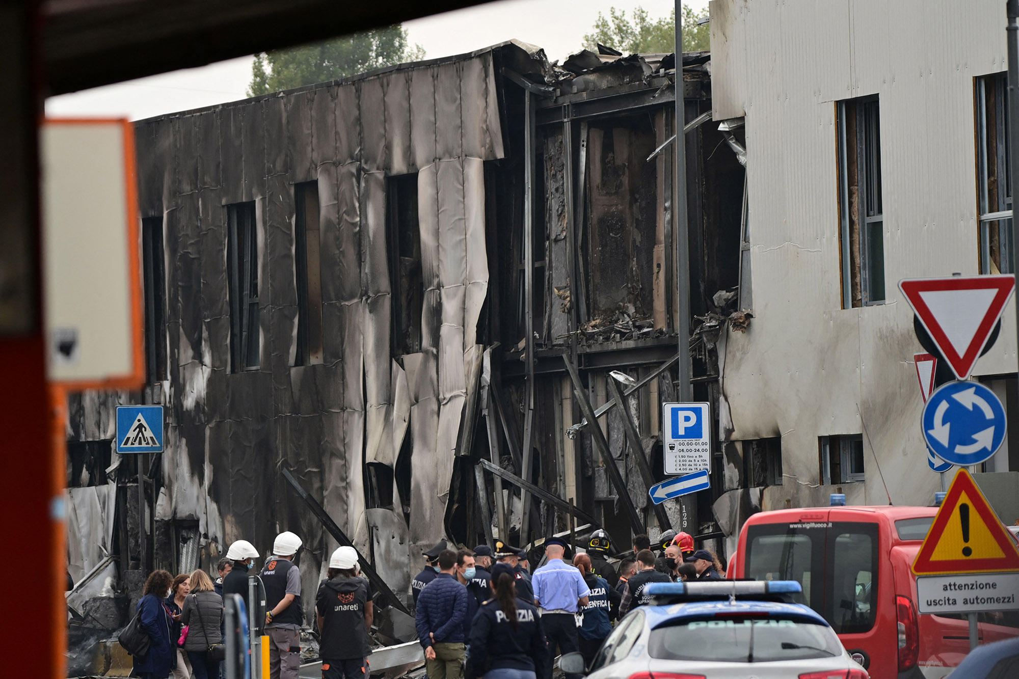 Police and rescue teams outside an office where a small plane crashed near&nbsp;Milan,&nbsp;on Oct.&nbsp;3.&nbsp;