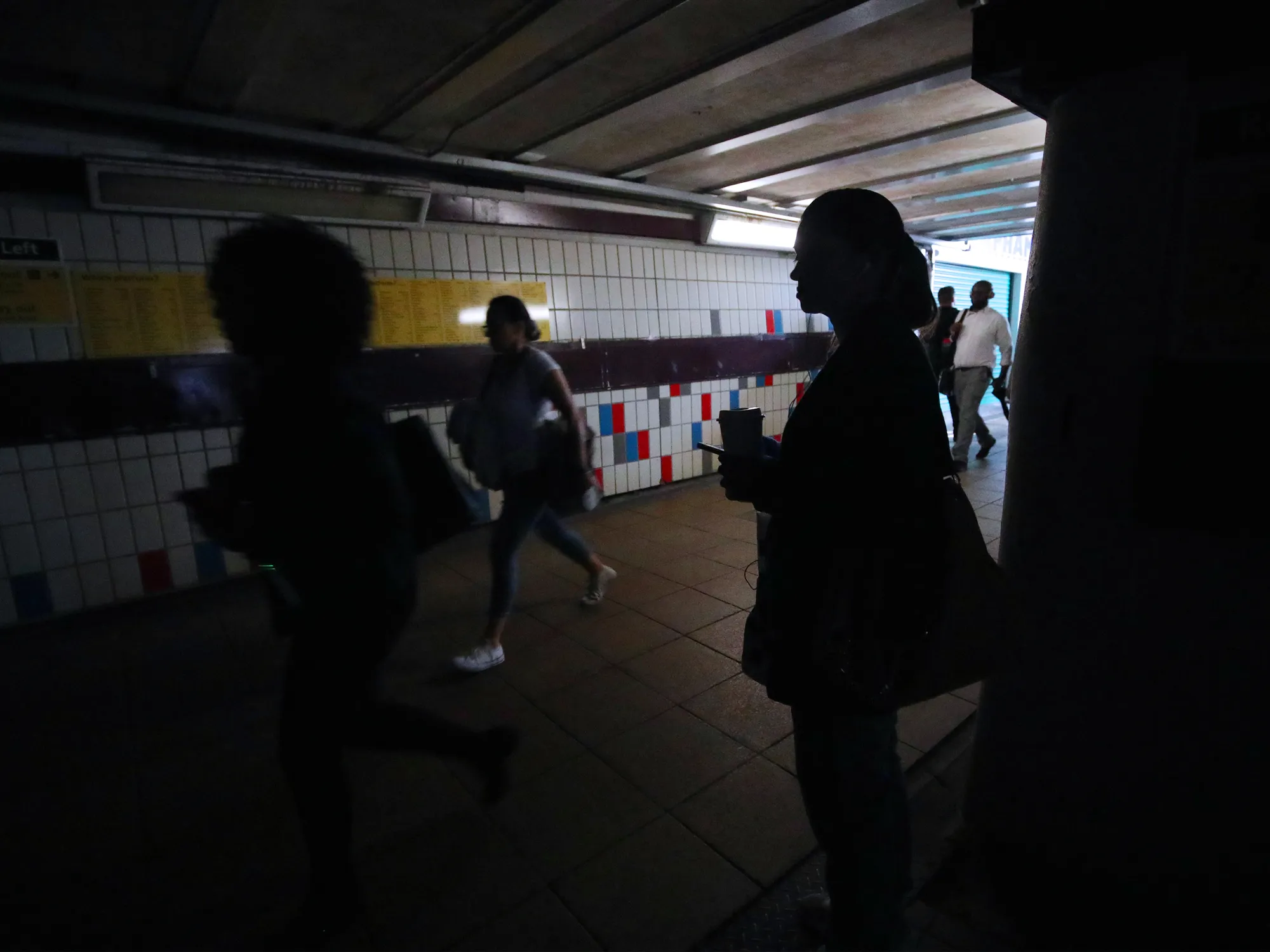 Passengers wait at Clapham Junction station in London on Aug. 9.