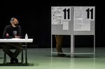 A voter casts their ballot at a polling station during early voting in Porto, Portugal, on Jan. 23.&nbsp;