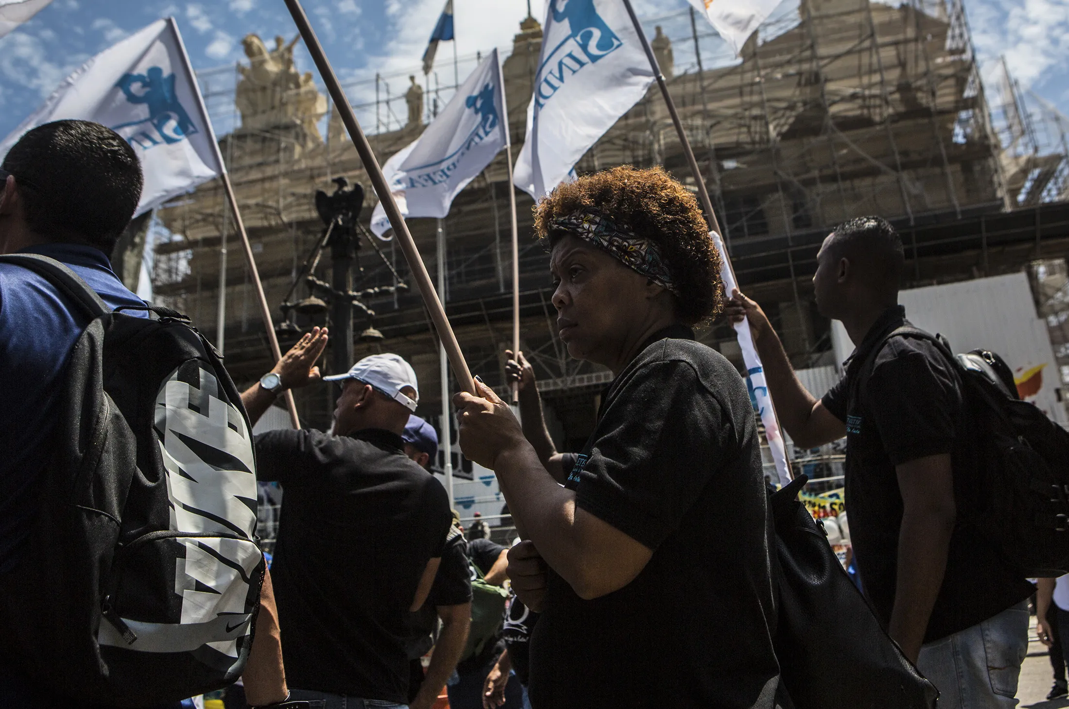 Demonstrators hold flags during a protest in front of the Legislative Palace in Rio de Janeiro, on Dec. 12, 2016.
