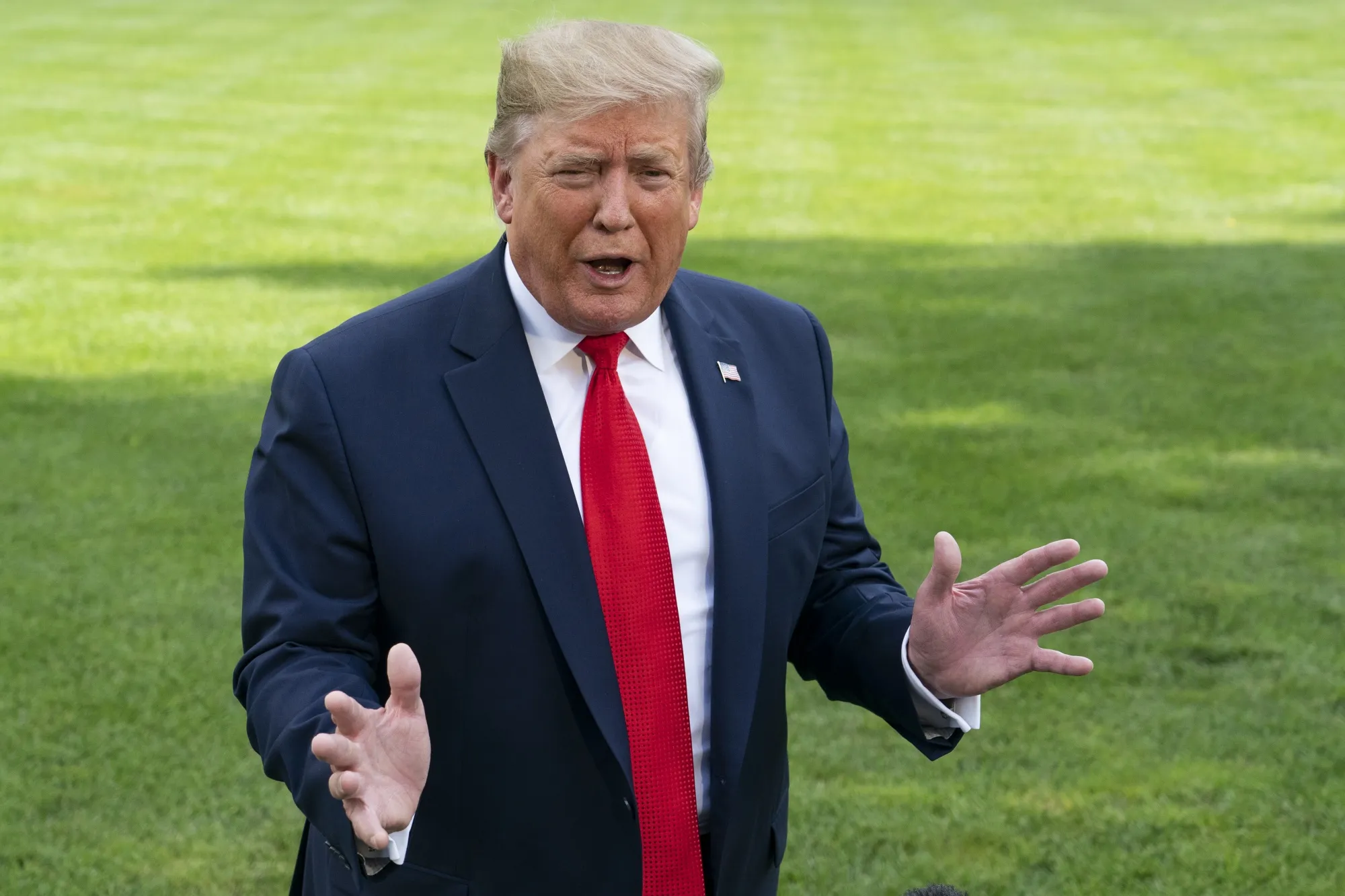U.S. President Donald Trump speaks to members of the media on the South Lawn of the White House.
