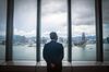 Paul Chan, Hong Kong's financial secretary, looks out at the city's skyline while posing for a photograph following a Bloomberg Television interview in Hong Kong, China, on Friday, June 5, 2020. Hong Kong is ready to defend the currency’s link to the U.S. dollar with the support of the mainland, and investors still retain confidence in the system, according Chan.