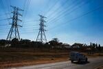 A vehicle drives under electrical power lines hanging from&nbsp;pylons in Pretoria.