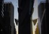 An American flag is reflected in the window of a building near the New York Stock Exchange.