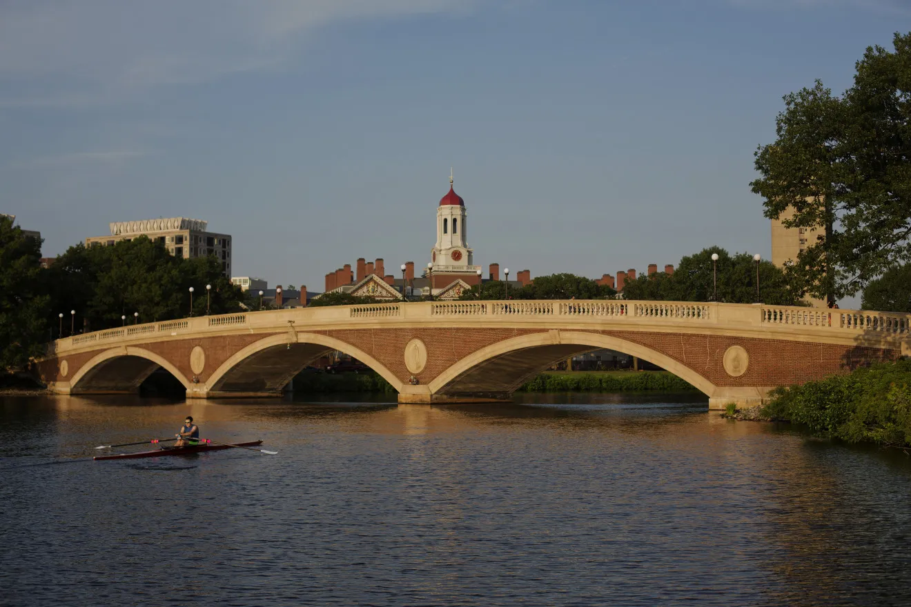 A sculler rows on the Charles River past the Harvard University campus in Cambridge, Massachusetts.