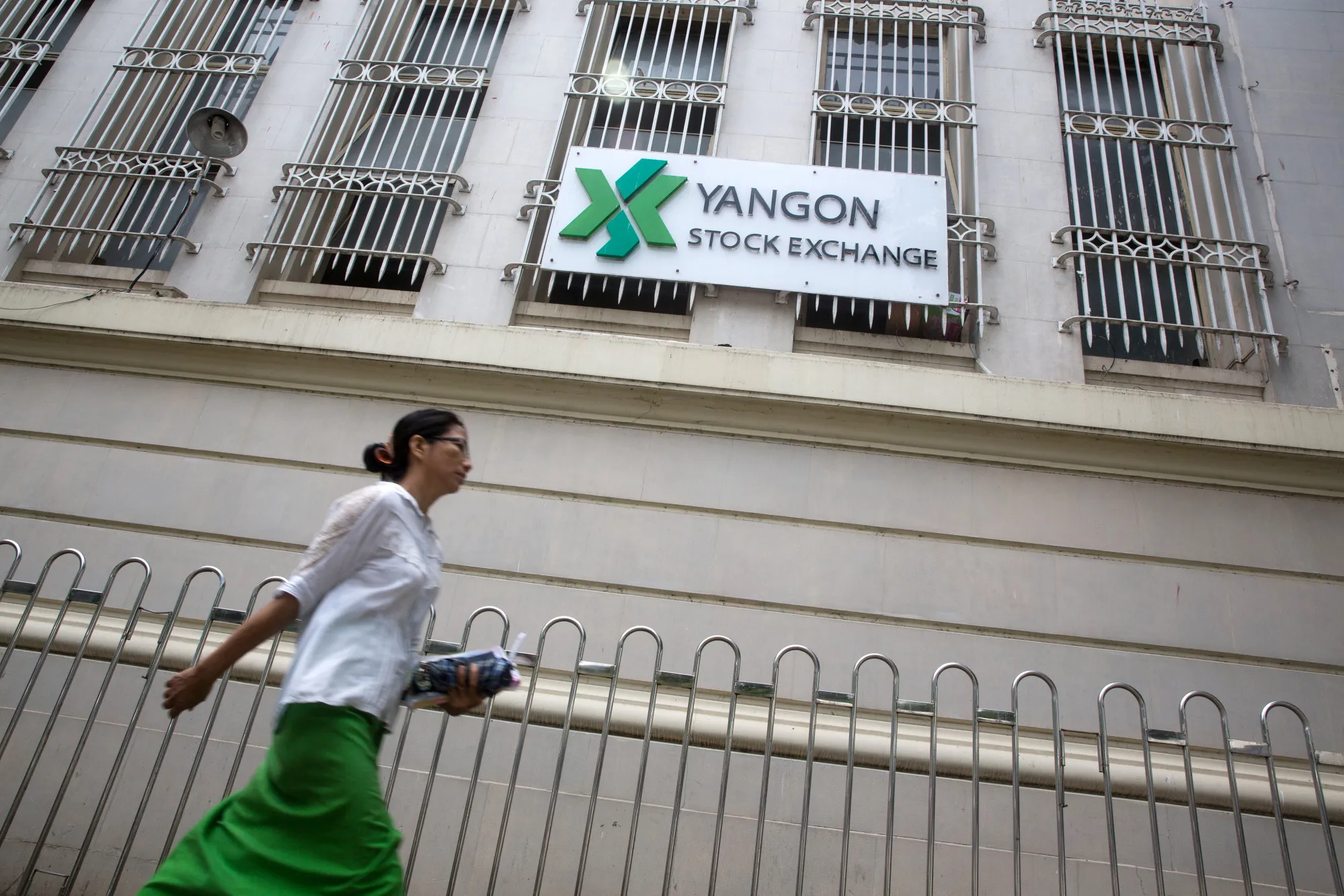 A pedestrian walks past the Yangon Stock Exchange in Myanmar.
