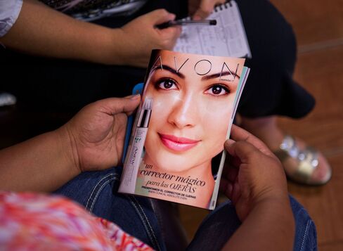 A customer views an Avon Products Inc. product catalog in McAllen, Texas, on Aug. 28, 2014.