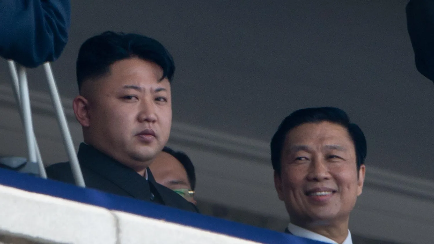 North Korean leader Kim Jong-Un (L) sits with China's Vice President Li Yuanchao (R) during a military parade at Kim Il-Sung square marking the 60th anniversary of the Korean war armistice in Pyongyang on July 27, 2013.
