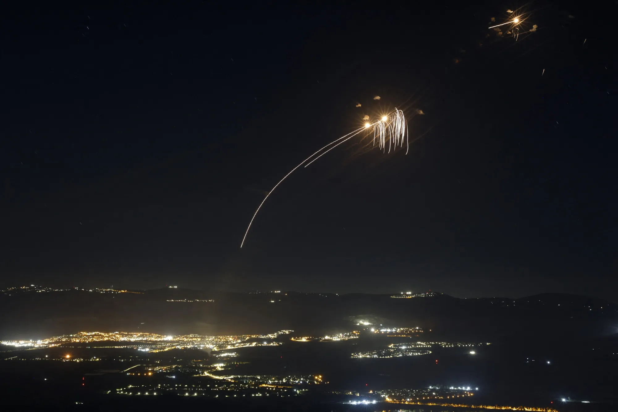 Rockets fired from southern Lebanon are intercepted by Israel's Iron Dome air defence system over northern Israel on Aug. 4.