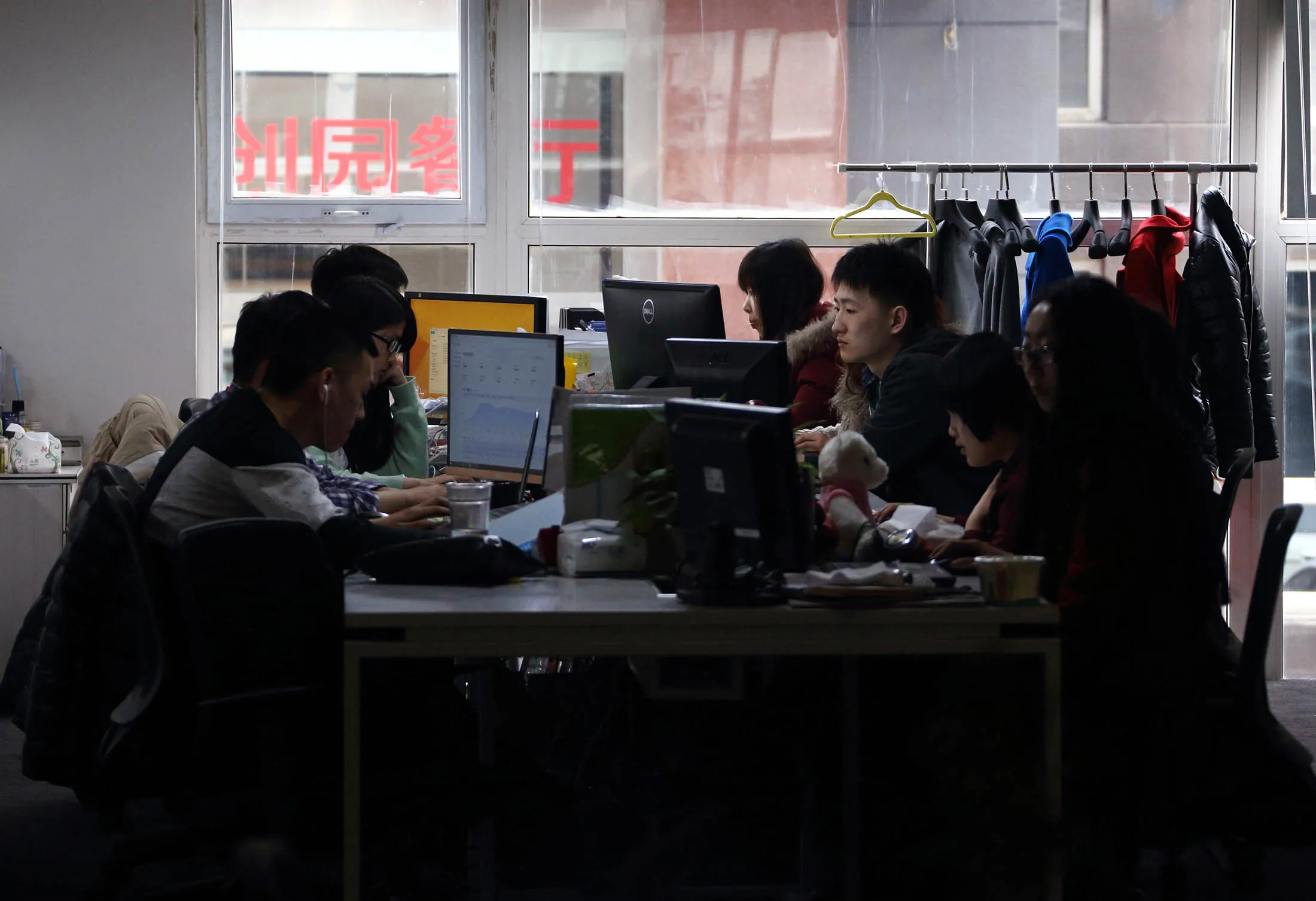 Workers use computers at their desks inside Tech Temple, a co-working space for start-up companies, in Beijing.
