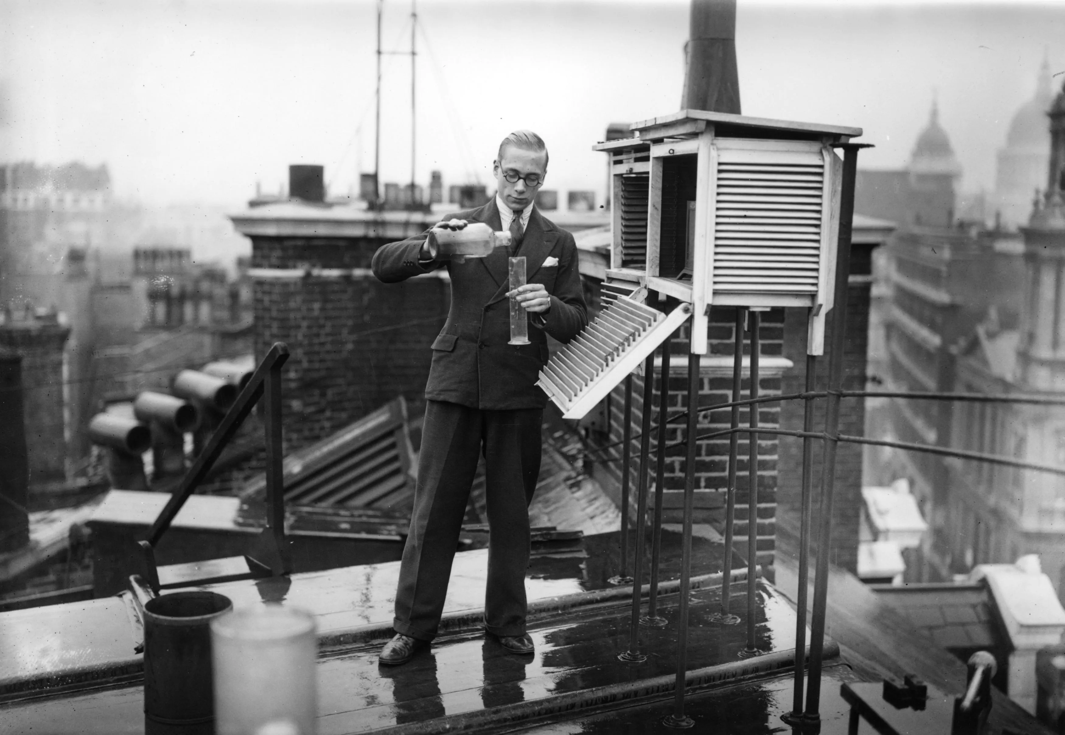 A weather clerk measures rainfall&nbsp;on a roof in London on Sept. 12, 1933.