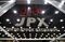 Tokyo Stock Exchange and Stock Boards As Japan Shares Dip With Banks As Volatility Returns to Markets